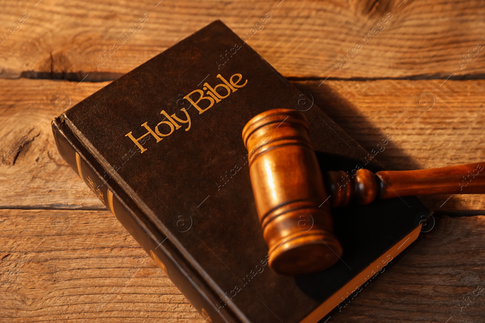 Judge's gavel and Bible on wooden table, above view Photo of Judge's gavel and Bible on wooden table, above view
