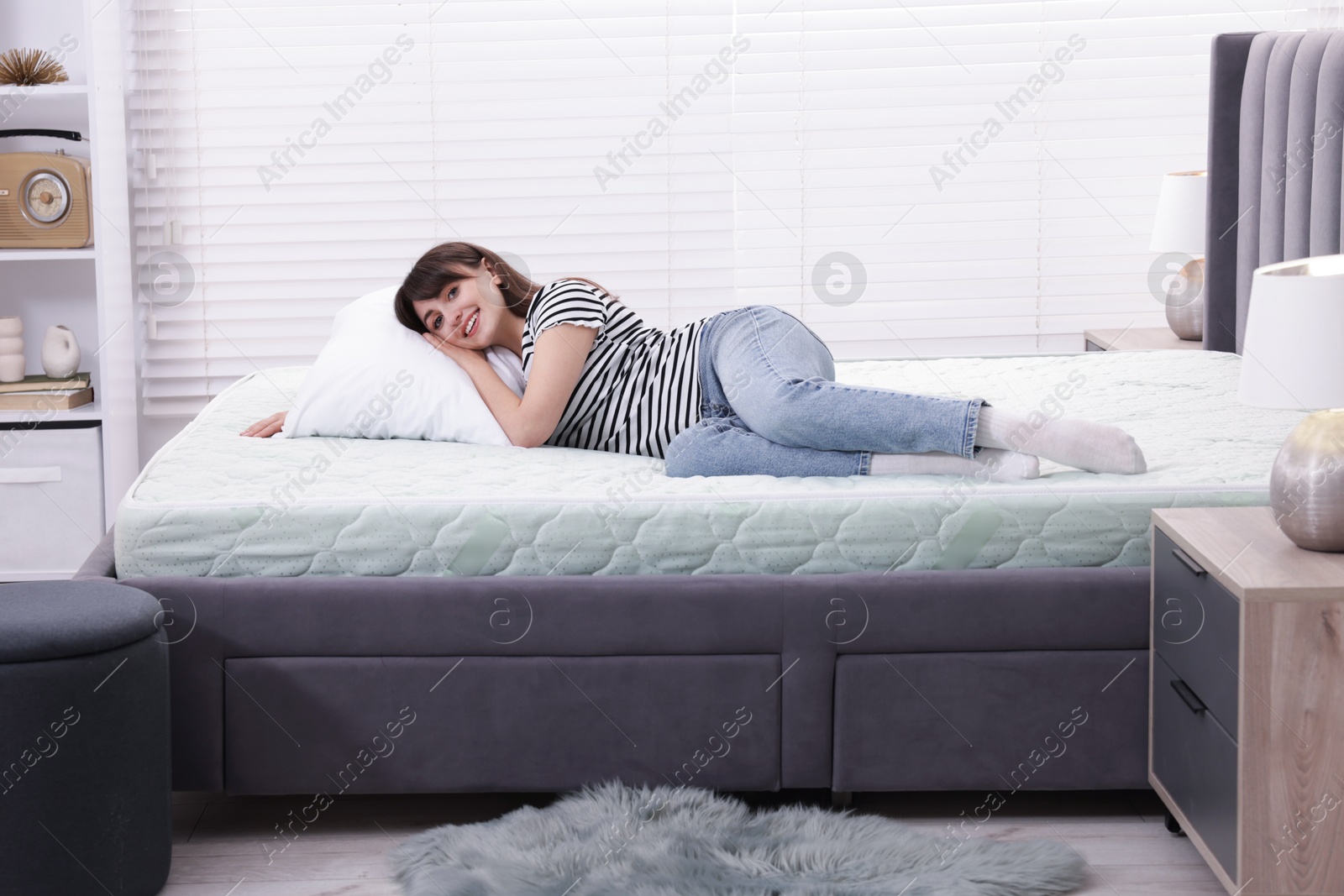 Beautiful woman lying on soft mattress at home Photo of Beautiful woman lying on soft mattress at home