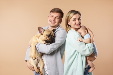 Photo of Happy family with little baby and cute dog on beige background