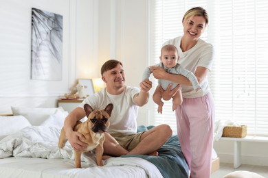 Photo of Happy family with little baby and cute dog at home