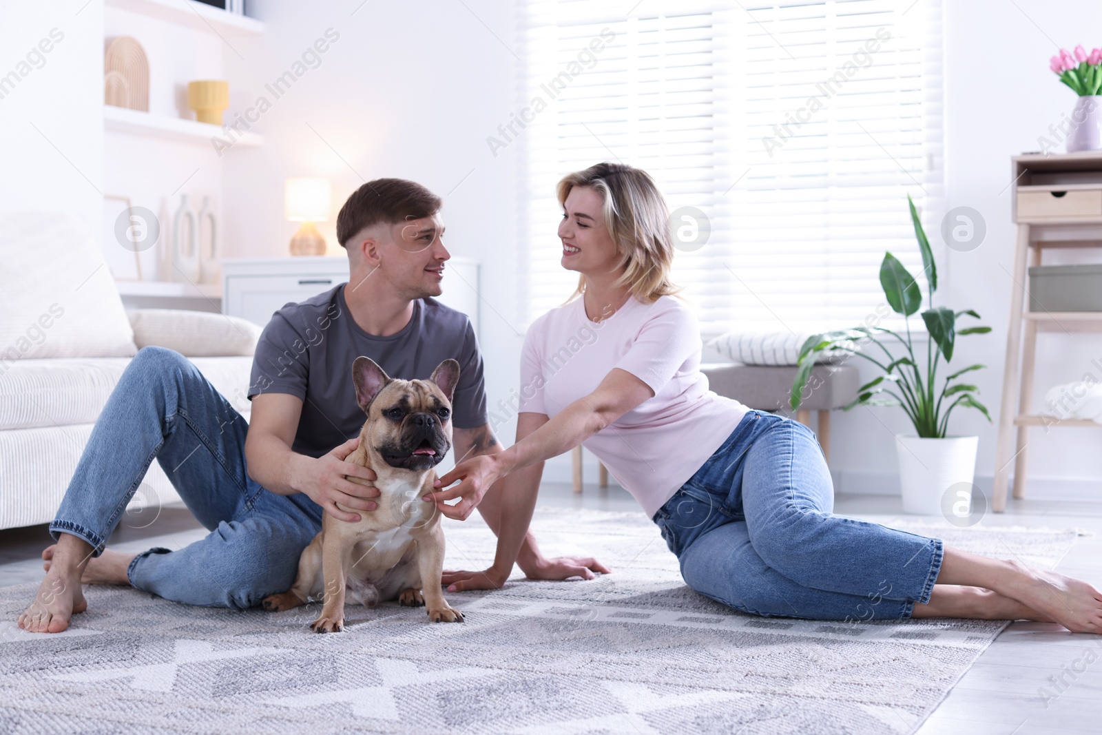 Happy couple with cute dog at home Photo of Happy couple with cute dog at home