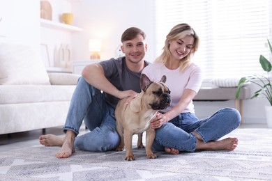 Photo of Happy couple with cute dog at home