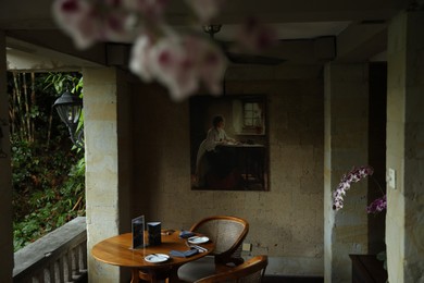 Photo of Bali, Indonesia - May 12, 2025: Modern restaurant with stylish wooden furniture