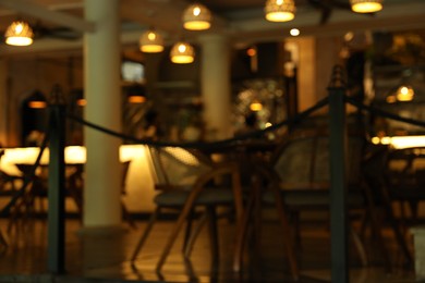Photo of Blurred view of modern cafe with stylish furniture