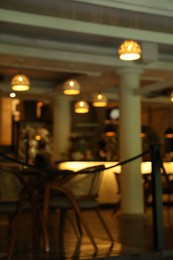 Photo of Blurred view of modern cafe with stylish furniture