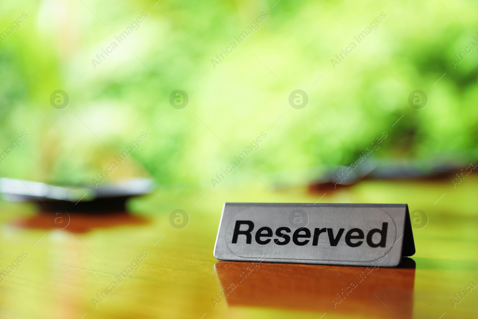 Sign with word Reserved on wooden table in restaurant, closeup. Space for text Photo of Sign with word Reserved on wooden table in restaurant, closeup. Space for text