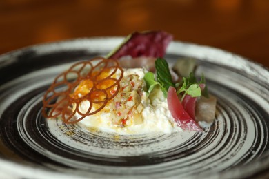 Photo of Tasty burrata ham salad served on plate, closeup