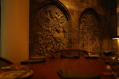 Photo of Bali, Indonesia - May 12, 2025: Modern restaurant with stylish wooden furniture