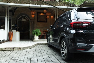 Photo of Cafe terrace and parked car in city