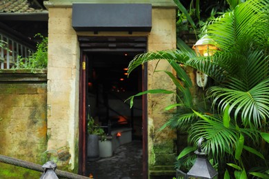 Photo of Stylish building with stone walls and plants in city