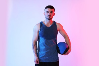 Photo of Man with medicine ball on color background