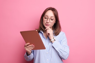 Photo of Woman with modern tablet on pink background
