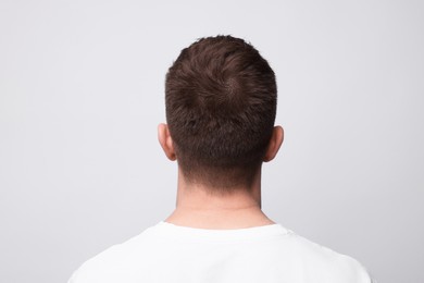 Photo of Man with light brown hair on background, back view