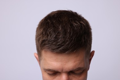 Photo of Man with brown hair on light background, closeup