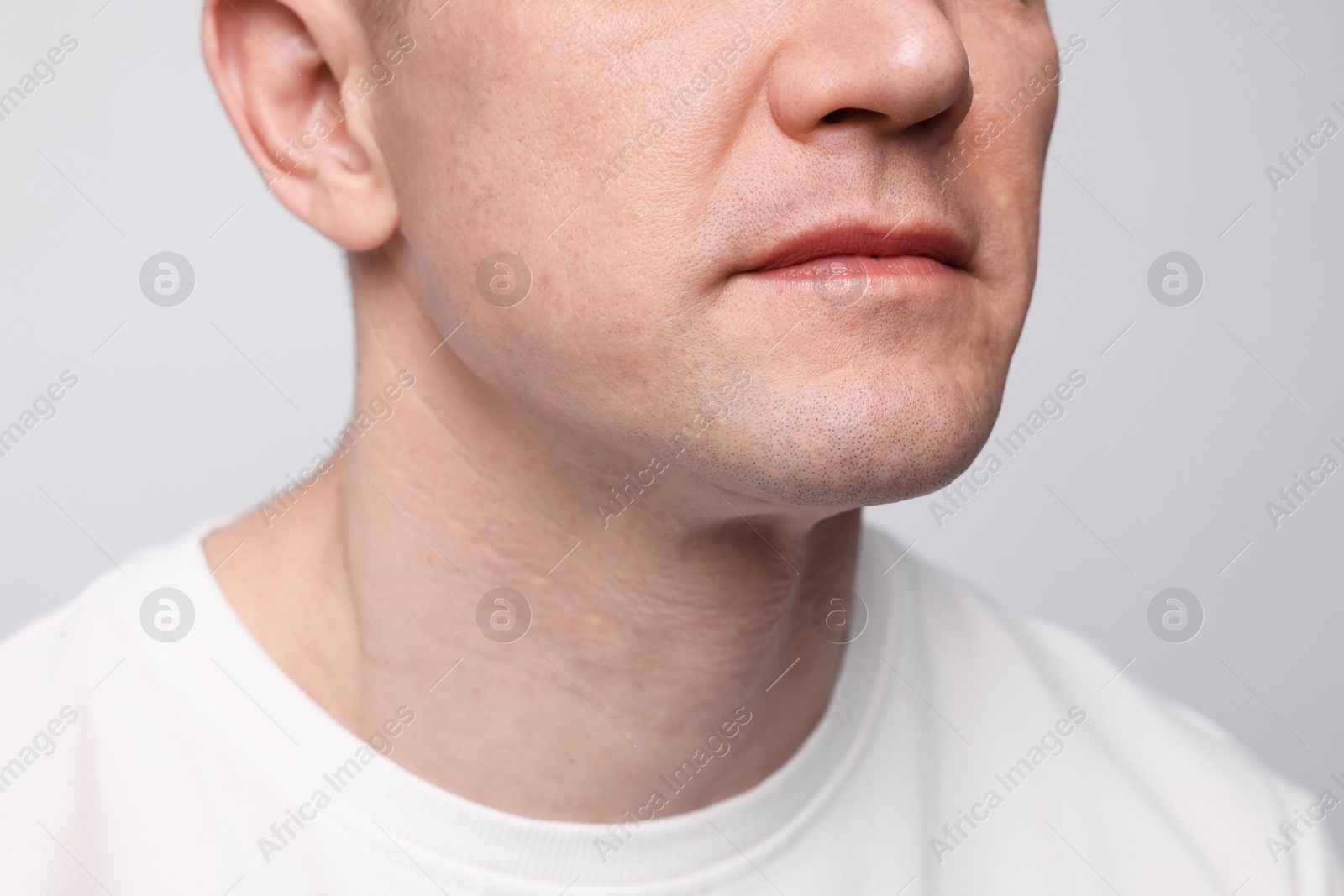 Clean shaven man on light background, closeup Photo of Clean shaven man on light background, closeup