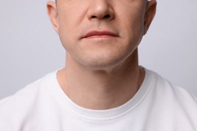 Photo of Clean shaven man on light background, closeup