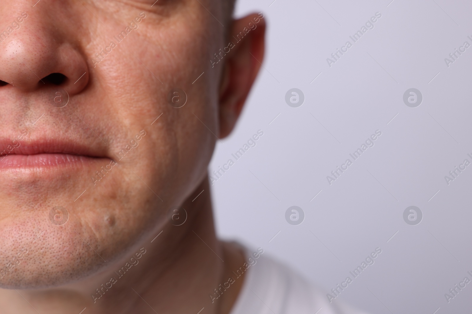 Photo of Clean shaven man on light background, closeup. Space for text