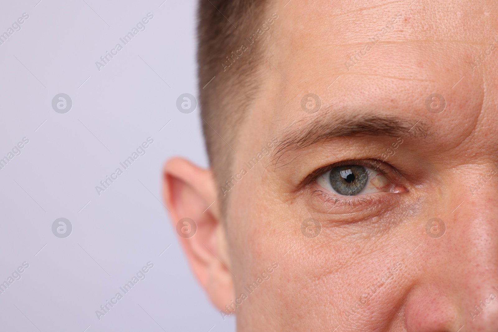 Handsome man on light background, closeup view Photo of Handsome man on light background, closeup view