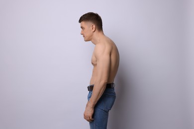 Photo of Man with bad posture on light background
