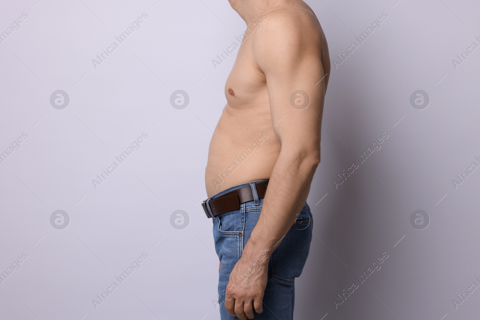 Man with belly on light background, closeup Photo of Man with belly on light background, closeup