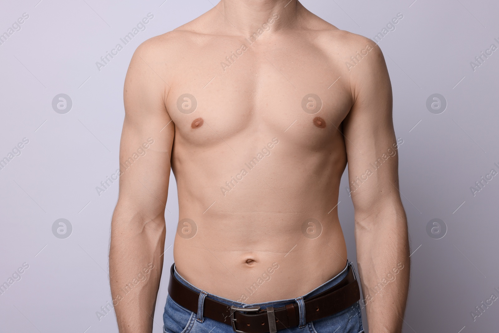 Confident shirtless man posing on light background, closeup Photo of Confident shirtless man posing on light background, closeup