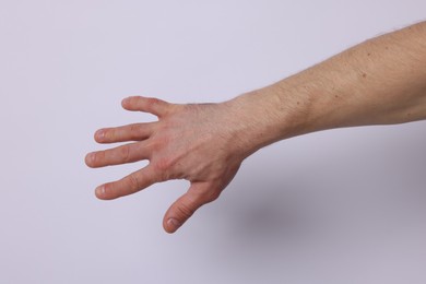 Photo of Man on light background, closeup of hand