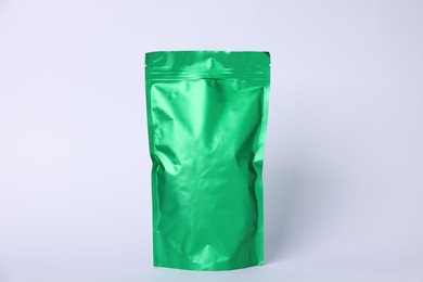 Photo of One zipper stand-up pouch on light grey background. Mockup for design