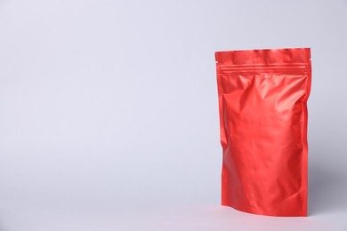 Photo of One zipper stand-up pouch on light grey background. Mockup for design