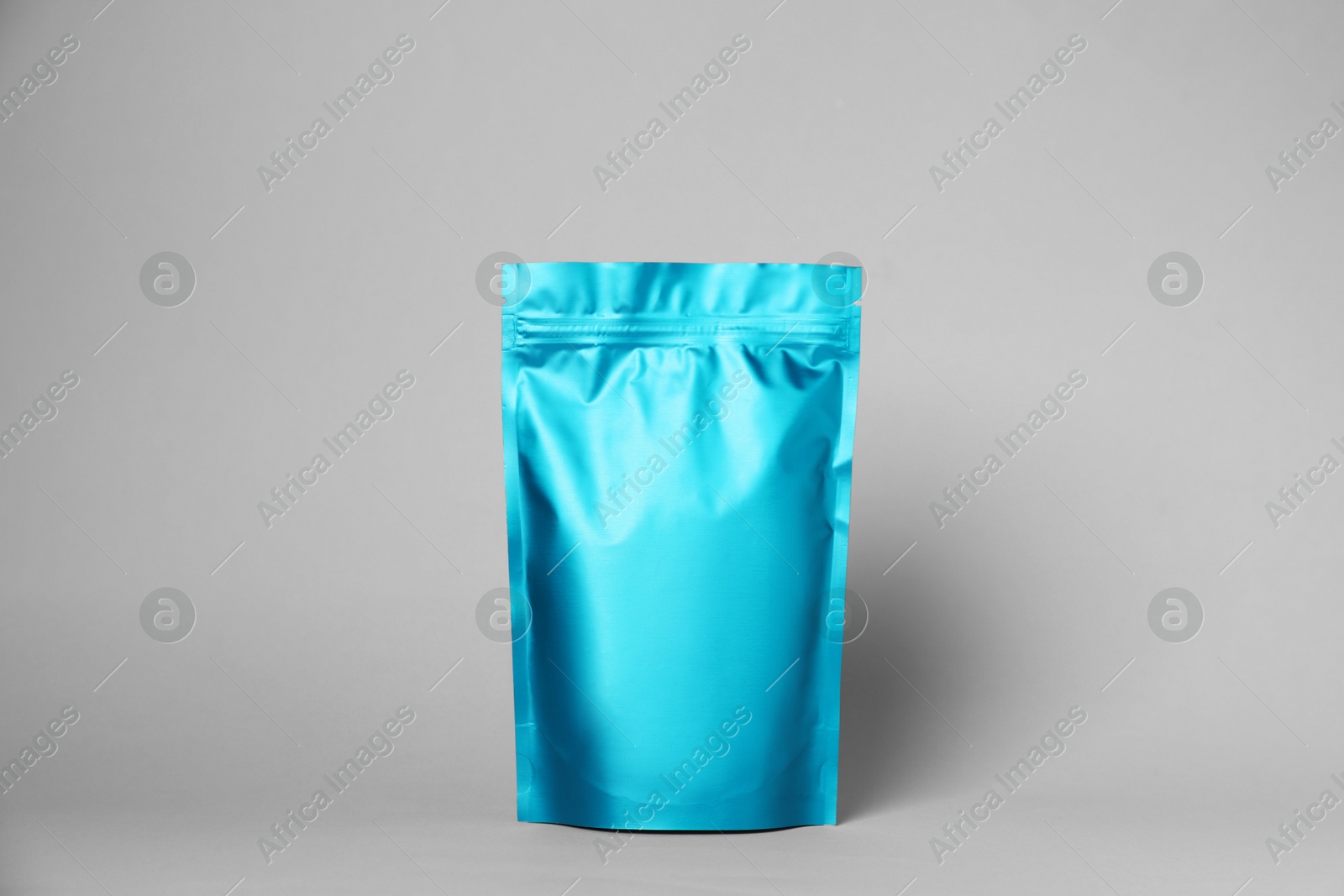 One zipper stand-up pouch on light grey background. Mockup for design Photo of One zipper stand-up pouch on light grey background. Mockup for design