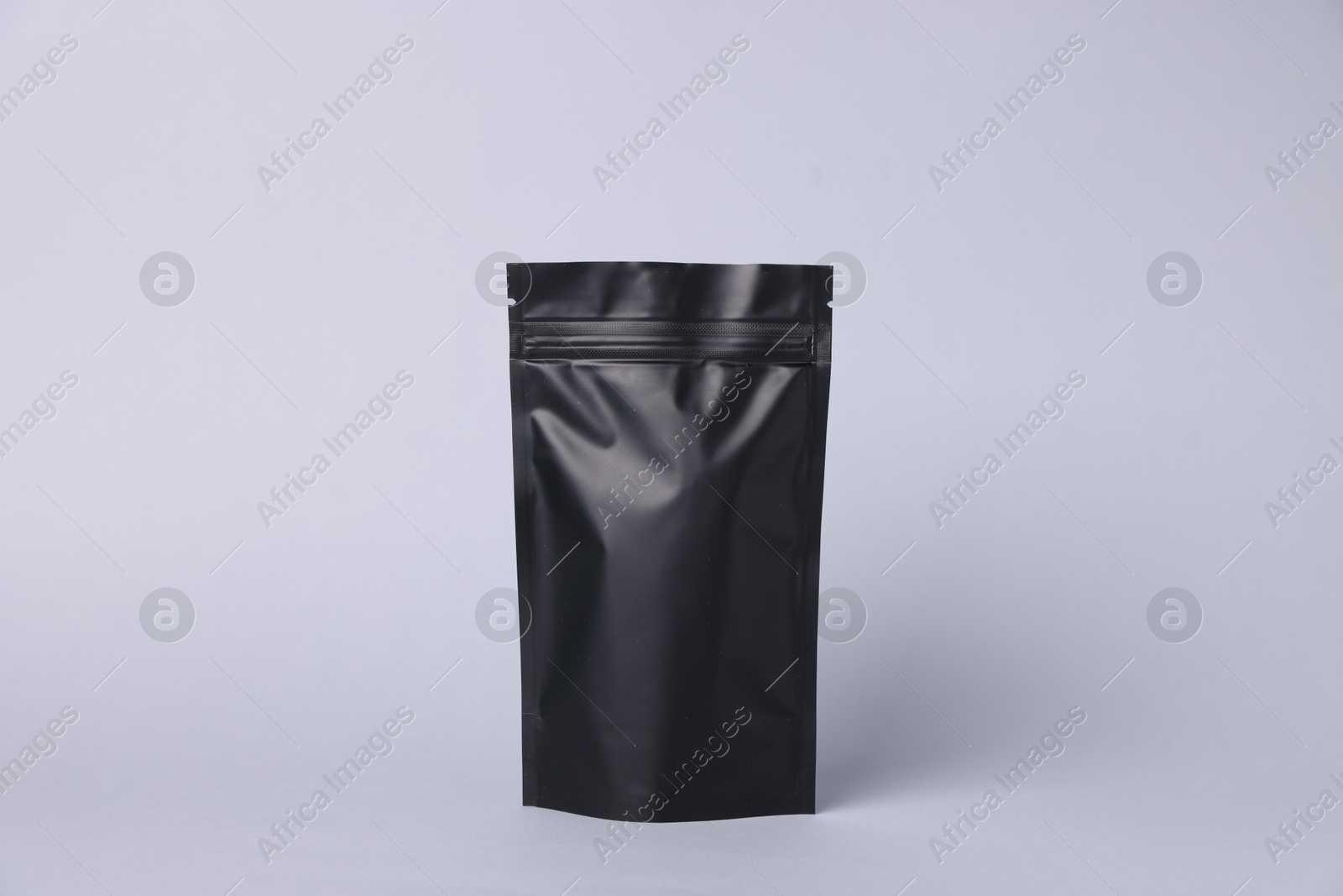 One zipper stand-up pouch on light grey background. Mockup for design Photo of One zipper stand-up pouch on light grey background. Mockup for design