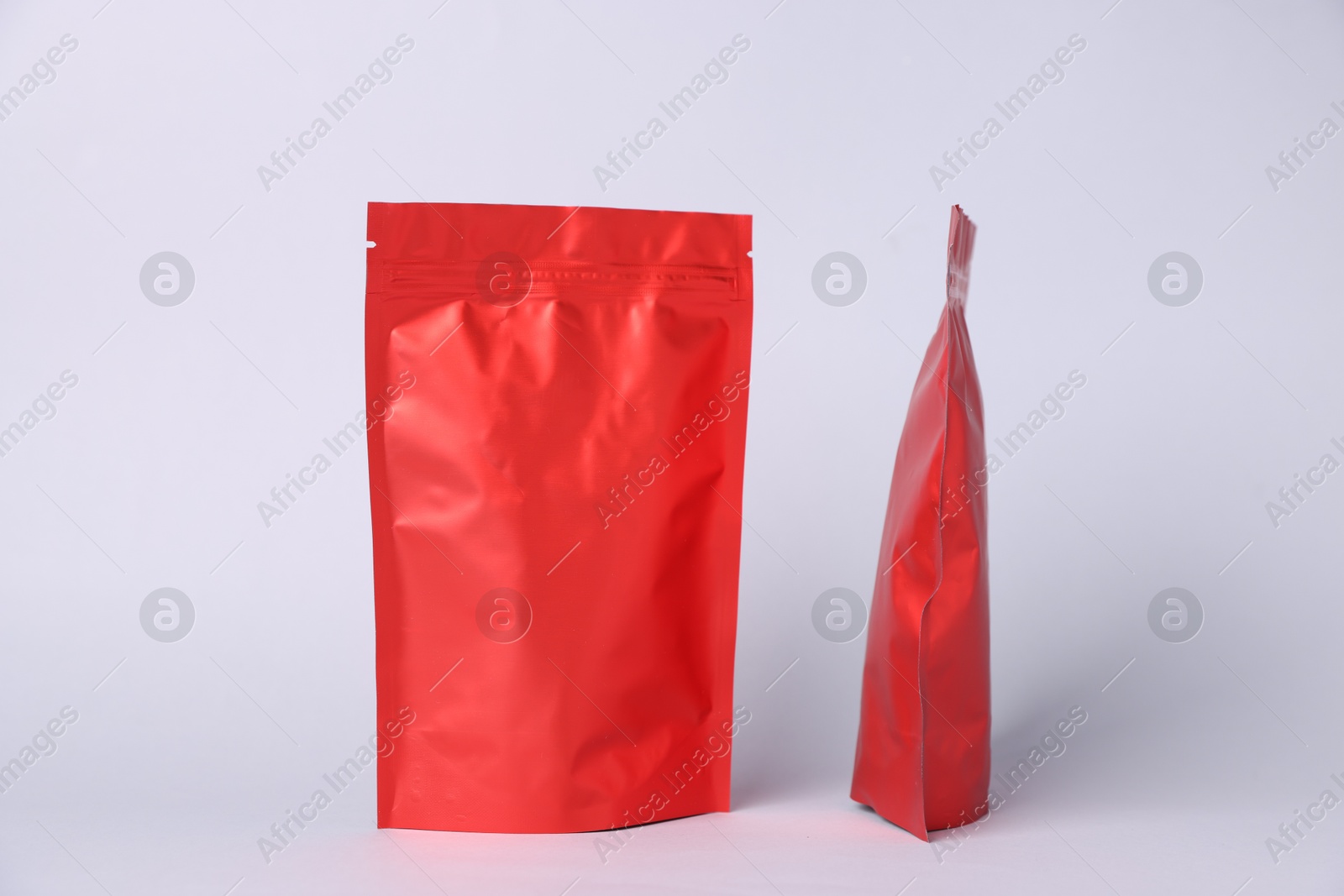 Photo of Zipper stand-up pouches on light grey background. Mockup for design