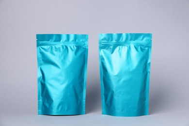 Photo of Zipper stand-up pouches on light grey background. Mockup for design