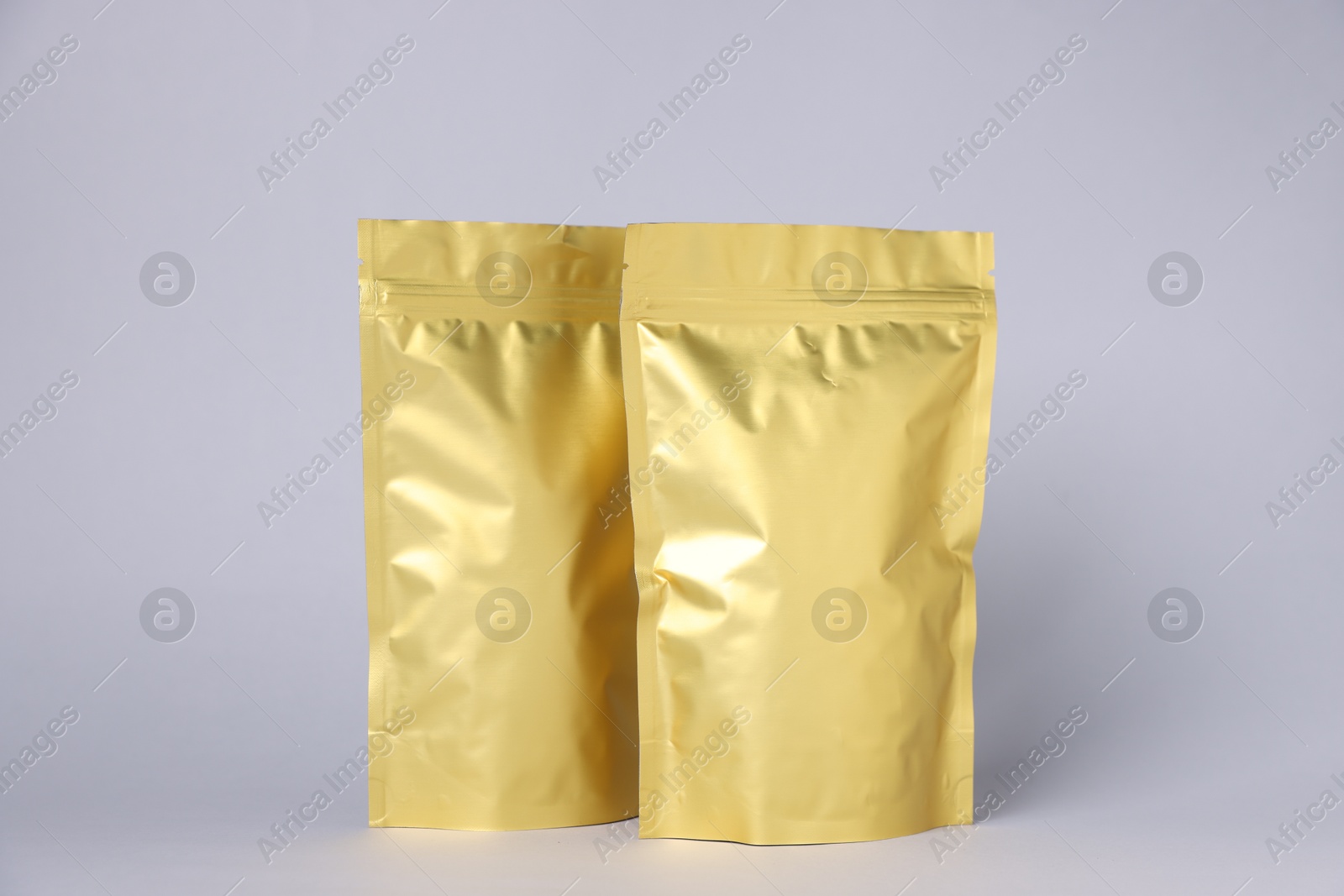 Photo of Zipper stand-up pouches on light grey background. Mockup for design
