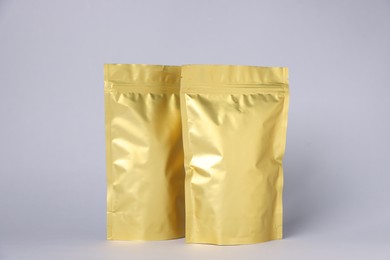 Photo of Zipper stand-up pouches on light grey background. Mockup for design