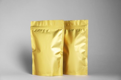 Photo of Zipper stand-up pouches on light grey background. Mockup for design