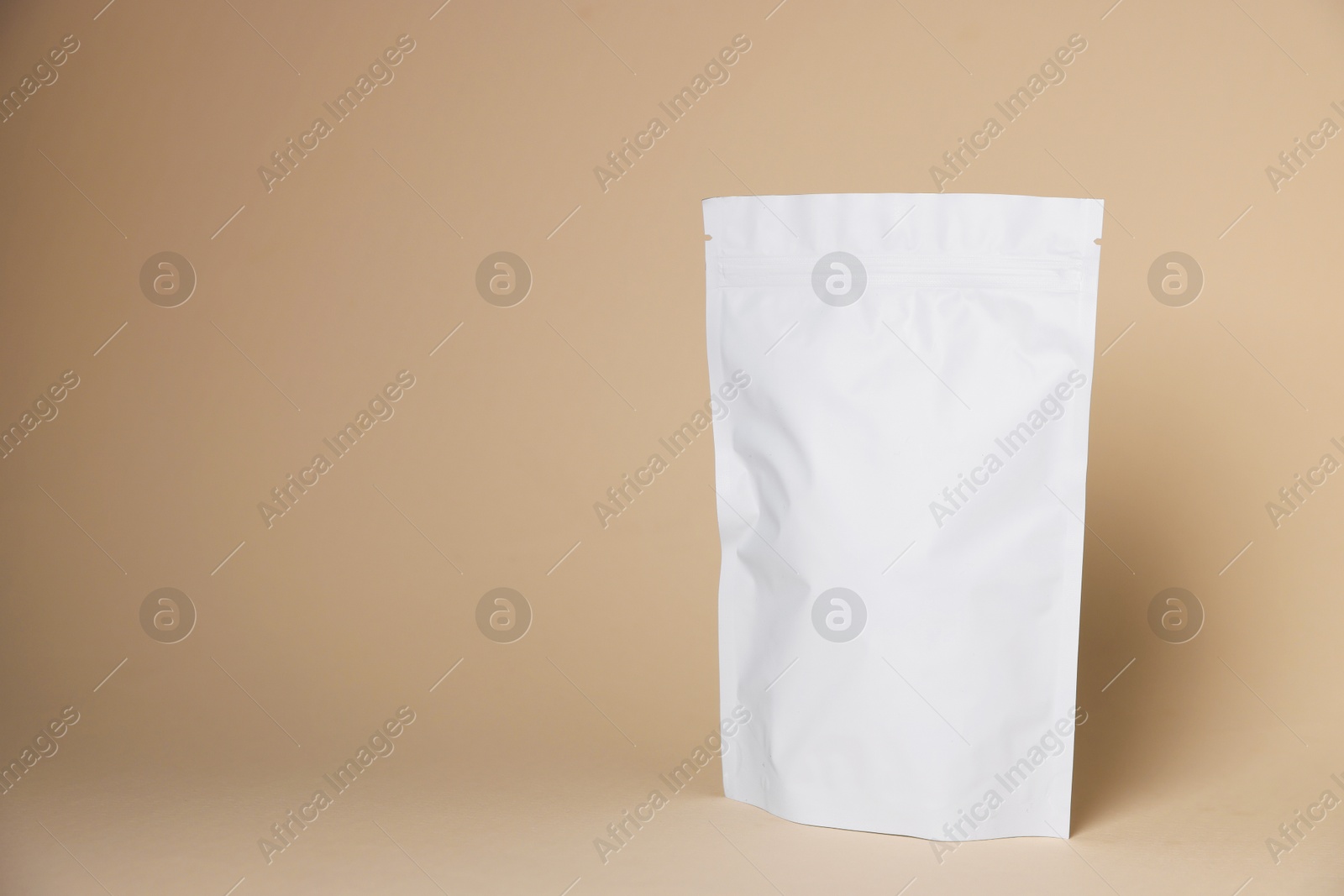 One zipper stand-up pouch on beige background. Mockup for design Photo of One zipper stand-up pouch on beige background. Mockup for design