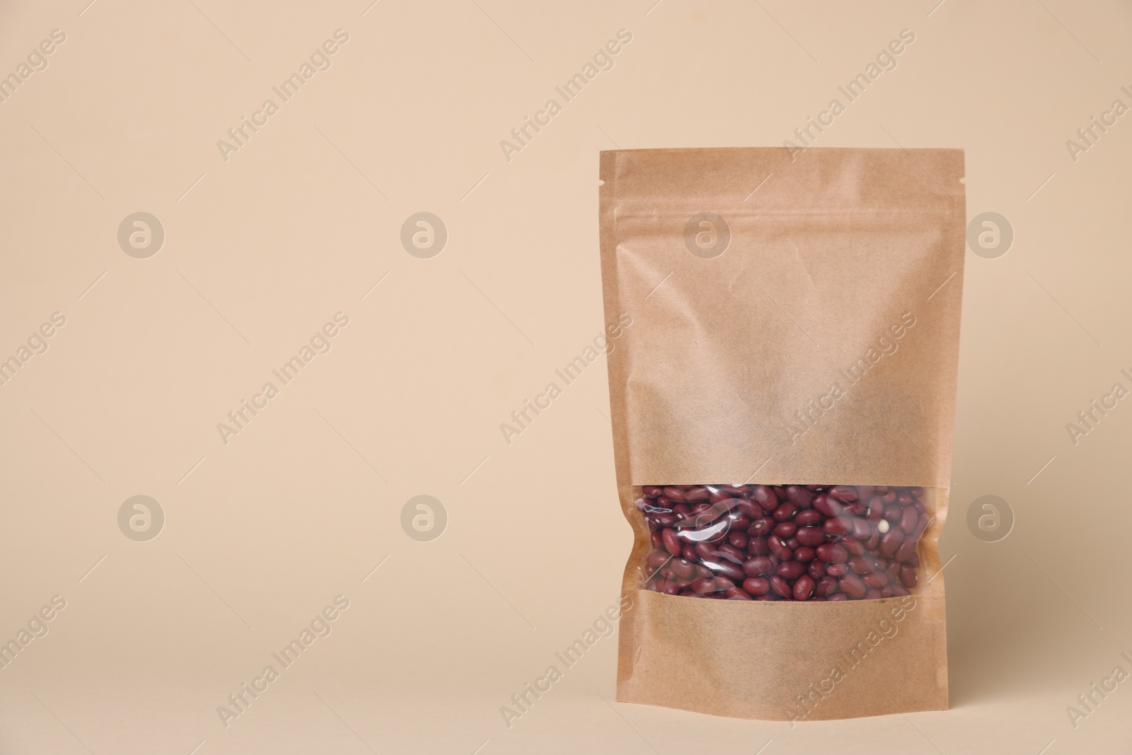 One zipper stand-up pouch with kidney beans on beige background. Mockup for design Photo of One zipper stand-up pouch with kidney beans on beige background. Mockup for design