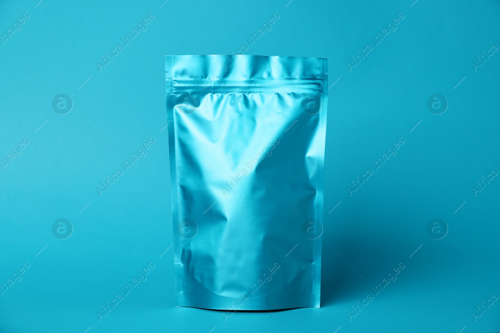 One zipper stand-up pouch on light blue background. Mockup for design Photo of One zipper stand-up pouch on light blue background. Mockup for design