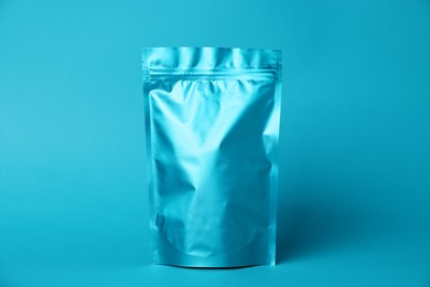 Photo of One zipper stand-up pouch on light blue background. Mockup for design