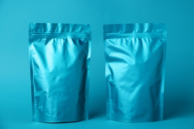 Photo of Zipper stand-up pouches on light blue background. Mockup for design
