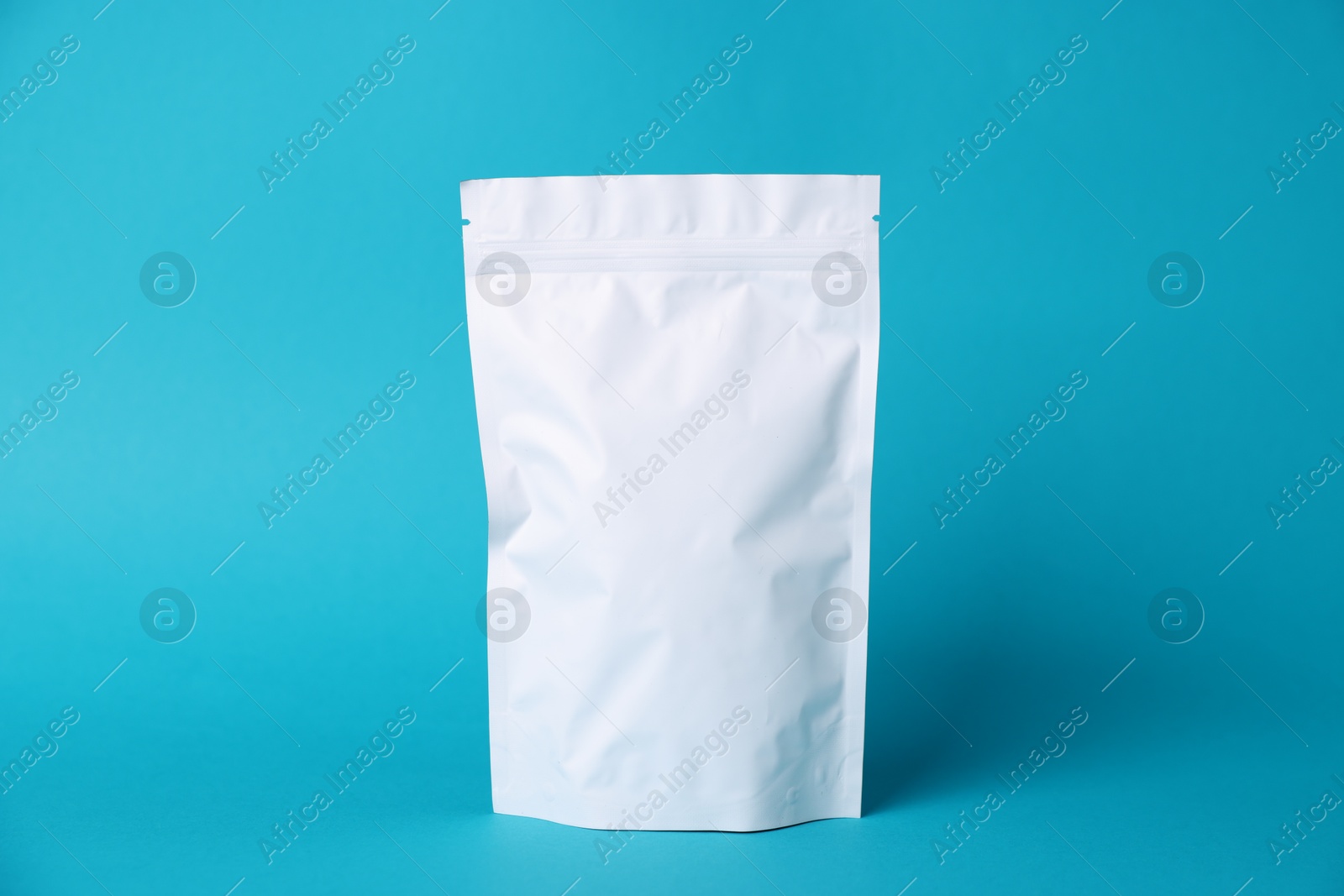 One zipper stand-up pouch on light blue background. Mockup for design Photo of One zipper stand-up pouch on light blue background. Mockup for design