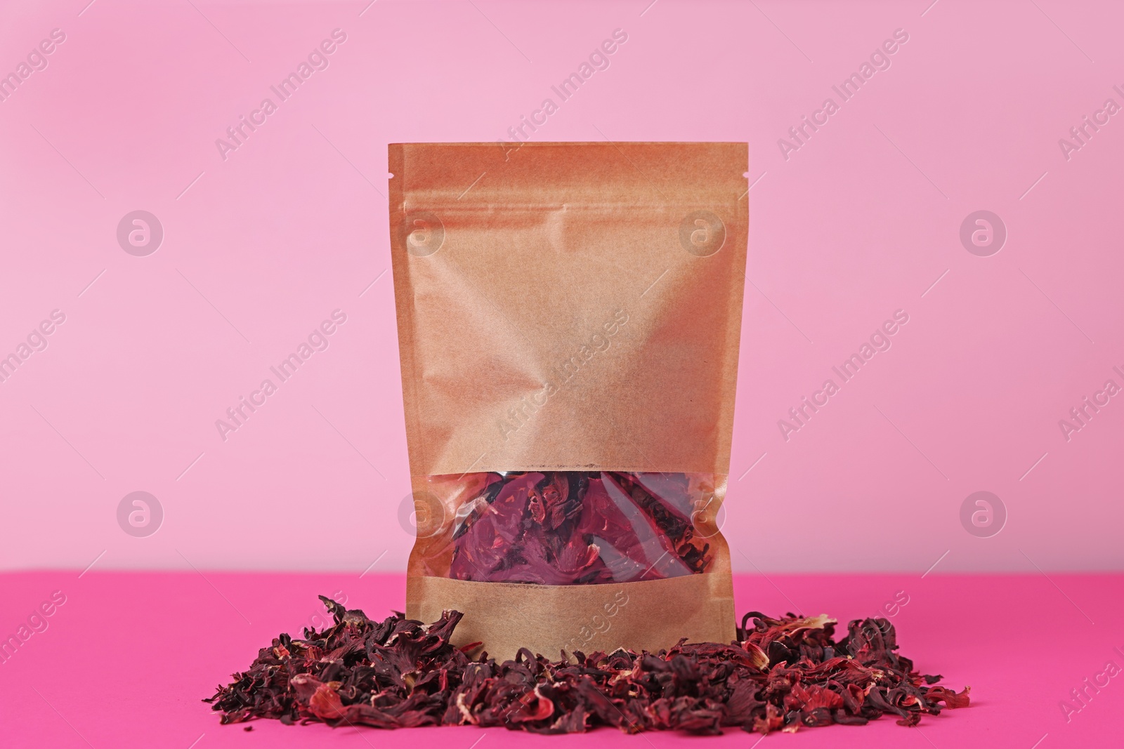 One zipper stand-up pouch with dry flowers on pink background. Mockup for design Photo of One zipper stand-up pouch with dry flowers on pink background. Mockup for design