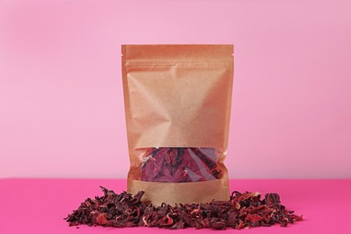 Photo of One zipper stand-up pouch with dry flowers on pink background. Mockup for design
