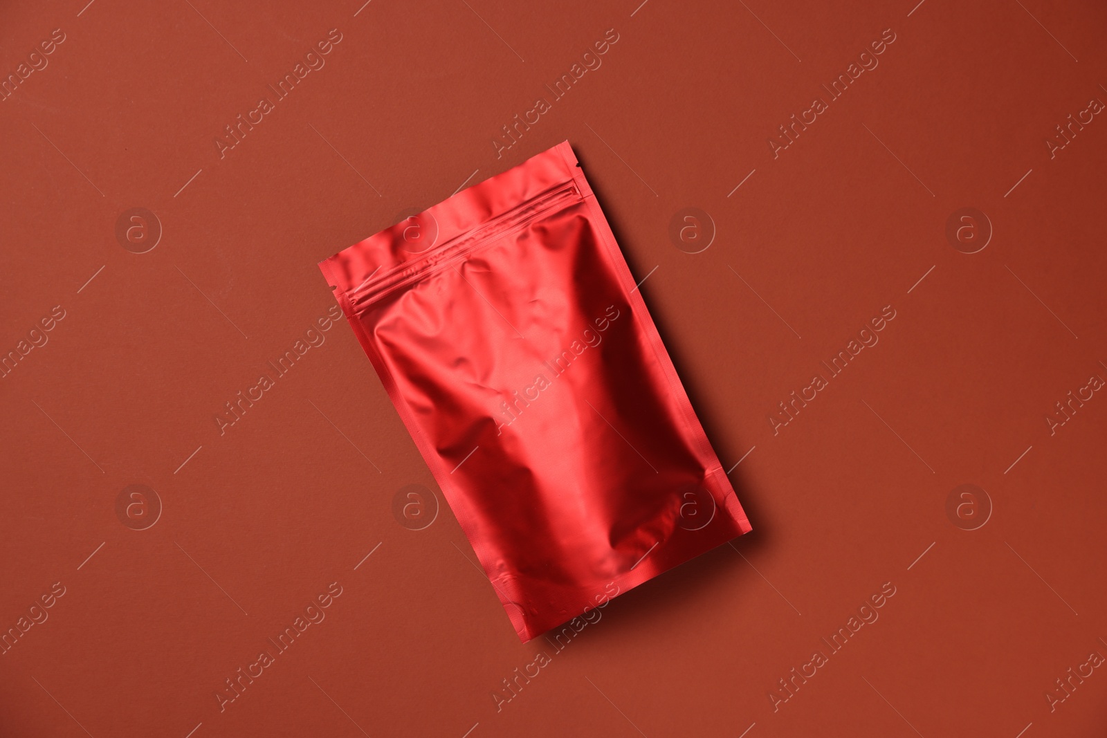 Photo of One zipper stand-up pouch on red background, top view. Mockup for design