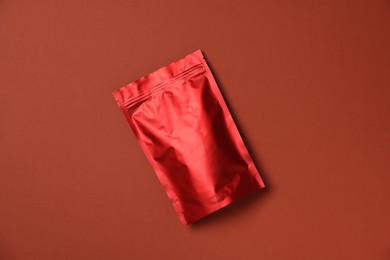 Photo of One zipper stand-up pouch on red background, top view. Mockup for design