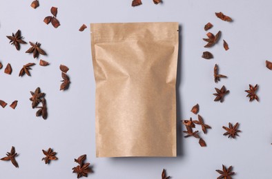 Photo of One zipper stand-up pouch with star anise on light grey background, flat lay. Mockup for design