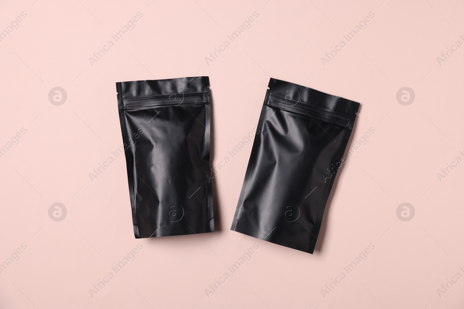 Zipper stand-up pouches on pink background, top view. Mockup for design Photo of Zipper stand-up pouches on pink background, top view. Mockup for design