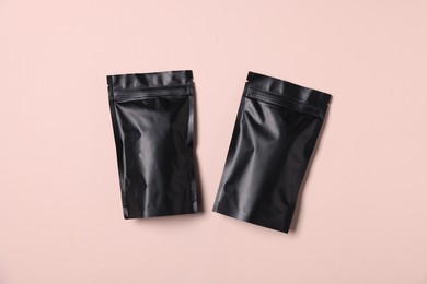 Photo of Zipper stand-up pouches on pink background, top view. Mockup for design