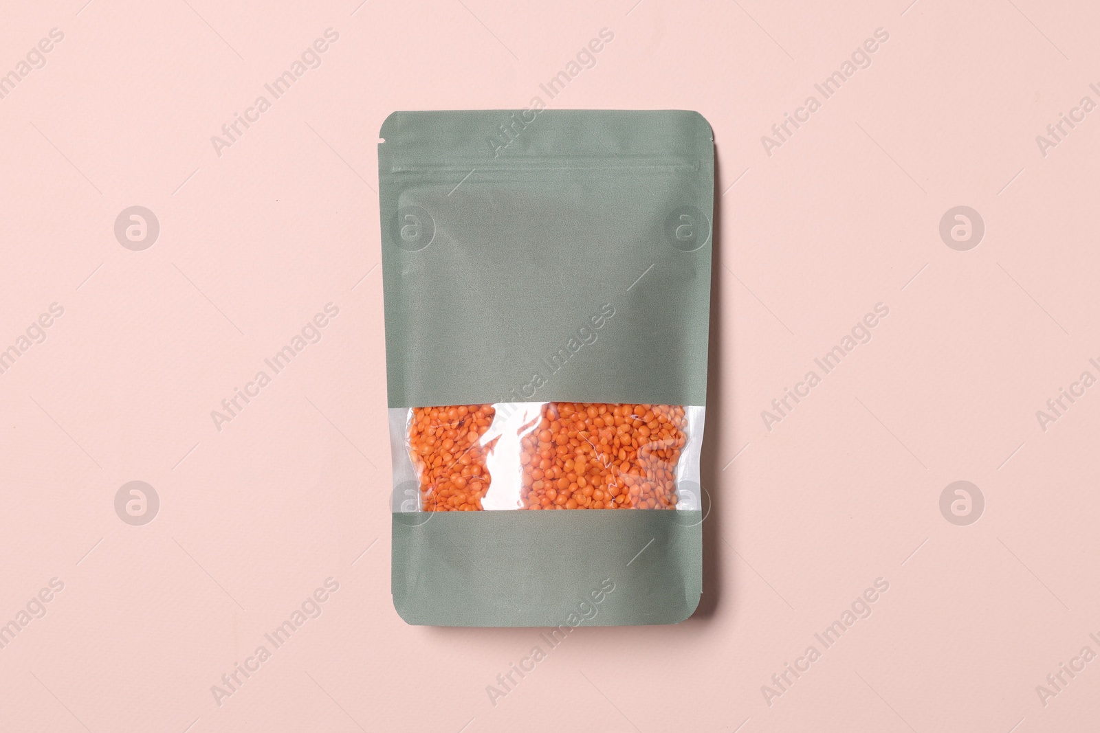 One zipper stand-up pouch with lentils on pink background, top view. Mockup for design Photo of One zipper stand-up pouch with lentils on pink background, top view. Mockup for design