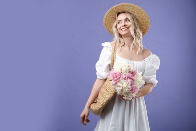 Photo of Happy woman with bouquet of beautiful peonies on purple background, space for text